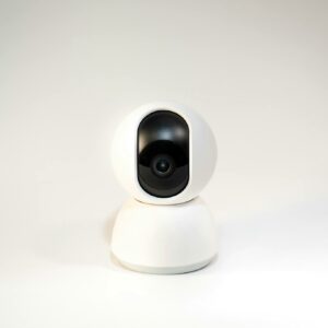 A sleek, white minimalistic smart home security camera on a white background.